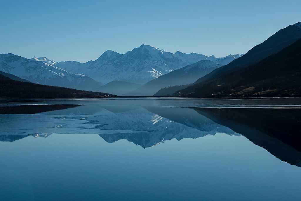 A calm, serene lake amongst mountains.